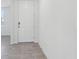 Bright entryway showcasing neutral tile flooring and a white front door at 3872 Giorgio Dr, Winter Haven, FL 33884