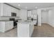 Bright and modern kitchen features a center island, stainless steel appliances, and granite countertops at 3872 Giorgio Dr, Winter Haven, FL 33884