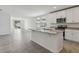 Open kitchen with white cabinets, granite countertops, stainless appliances and tile flooring at 3872 Giorgio Dr, Winter Haven, FL 33884