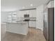 Modern kitchen with island, stainless steel appliances, granite counters and ample storage at 3872 Giorgio Dr, Winter Haven, FL 33884