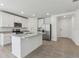 Well-lit kitchen featuring white cabinets, granite countertops, stainless steel appliances, and an island at 3872 Giorgio Dr, Winter Haven, FL 33884