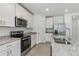 Bright kitchen with white cabinets, stainless steel appliances, and granite countertops at 3872 Giorgio Dr, Winter Haven, FL 33884