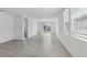 Bright living room features tile flooring, slider glass doors to the backyard, and white walls at 3872 Giorgio Dr, Winter Haven, FL 33884