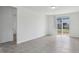 Bright living room features tile flooring, slider glass doors to the backyard, and white walls at 3872 Giorgio Dr, Winter Haven, FL 33884
