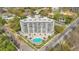 Breathtaking aerial view of the building highlighting its elegant design and features a pool and patio area, nestled among trees at 401 E Robinson St # 202, Orlando, FL 32801