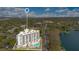 Drone shot outlines this building highlighting its pool and lakeside location, offering a serene escape with city accessibility at 401 E Robinson St # 202, Orlando, FL 32801