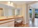 Bathroom featuring vanity area, mirrors, stool, and access to other rooms at 401 E Robinson St # 202, Orlando, FL 32801