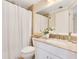 Bathroom features a granite countertop, white cabinets, toilet, and shower with curtain at 401 E Robinson St # 202, Orlando, FL 32801