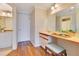 Bathroom featuring hardwood floors, light walls, vanity, large mirror and doorway to a second bathroom at 401 E Robinson St # 202, Orlando, FL 32801