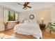 Bedroom featuring hardwood floors, fan, light walls, dresser, and city views from a window at 401 E Robinson St # 202, Orlando, FL 32801