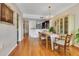 Cozy dining room featuring hardwood floors, chandelier, and direct access to a modern kitchen at 401 E Robinson St # 202, Orlando, FL 32801