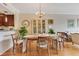 Dining room showcasing hardwood floors, chandelier, and an open view of the modern kitchen at 401 E Robinson St # 202, Orlando, FL 32801