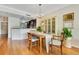 Elegant dining area with hardwood floors, chandelier, and an open view of the modern kitchen at 401 E Robinson St # 202, Orlando, FL 32801