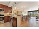 Open layout of kitchen, dining, and living area with tile and hardwood floors at 401 E Robinson St # 202, Orlando, FL 32801