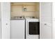 Laundry area with large, white washer and dryer and closet storage space at 401 E Robinson St # 202, Orlando, FL 32801