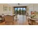 Living room with hardwood floors, fan, light walls, city views and access to a balcony at 401 E Robinson St # 202, Orlando, FL 32801
