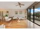 Living room with hardwood floors, fan, light walls, city views and access to a balcony at 401 E Robinson St # 202, Orlando, FL 32801
