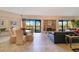 Open-concept living room with fireplace, balcony access, and dining area with seating for six at 401 E Robinson St # 202, Orlando, FL 32801