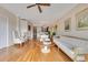 Bright living room featuring hardwood floors, fan, neutral walls, and elegant furnishings at 401 E Robinson St # 202, Orlando, FL 32801