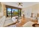 Living room with hardwood floors, fan, light walls, city views, balcony and closet at 401 E Robinson St # 202, Orlando, FL 32801