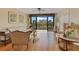 Living room with hardwood floors, fan, light walls, city views and access to a balcony at 401 E Robinson St # 202, Orlando, FL 32801