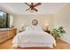 Bright bedroom with a large window view, hardwood floors, ceiling fan and elegant decor at 401 E Robinson St # 202, Orlando, FL 32801
