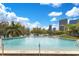 Outdoor swimming pool with blue water and views of city buildings and puffy clouds in a blue sky at 401 E Robinson St # 202, Orlando, FL 32801
