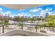 Balcony view of the pool area with palm trees and a beautiful city skyline at 401 E Robinson St # 202, Orlando, FL 32801