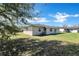 Spacious backyard with lush green grass and partial tree coverage at 4207 Chateau Rd, Orlando, FL 32808
