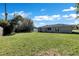 This large backyard features a grassy area perfect for outdoor activities at 4207 Chateau Rd, Orlando, FL 32808