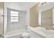 Updated bathroom with marble-look tile surround and modern vanity at 4207 Chateau Rd, Orlando, FL 32808