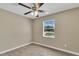 This bedroom features neutral walls, wood-look tile floors, and a ceiling fan at 4207 Chateau Rd, Orlando, FL 32808
