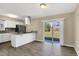 Open kitchen featuring stainless steel appliances, granite countertops, and a sliding glass door to the backyard at 4207 Chateau Rd, Orlando, FL 32808