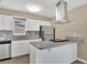 Bright kitchen featuring stainless steel appliances, granite countertops, and white cabinetry at 4207 Chateau Rd, Orlando, FL 32808