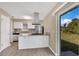 Modern kitchen with stainless steel appliances, granite countertops, and a view of the backyard at 4207 Chateau Rd, Orlando, FL 32808
