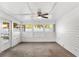 Bright sunroom featuring white walls and ceiling, ceiling fan, and multiple windows at 4306 Pine Lake Dr, St Cloud, FL 34769