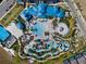 Aerial view of community pool, water slides, lazy river and abundant lounge chairs at 4353 Lana Ave, Davenport, FL 33897