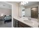 Bathroom featuring double sinks, white countertops, wood cabinets, and a mirror with vanity lights at 4353 Lana Ave, Davenport, FL 33897