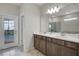 Modern bathroom featuring double sinks, granite countertops, and access to the pool area at 4353 Lana Ave, Davenport, FL 33897