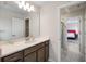 Bathroom with a large mirror, modern lighting, and an open doorway to a bedroom at 4353 Lana Ave, Davenport, FL 33897
