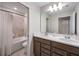 Bathroom featuring double sinks, white countertops, wood cabinets, and a tiled shower/tub combo at 4353 Lana Ave, Davenport, FL 33897