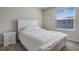 Neutral bedroom featuring a bright window, white furniture, and soft carpet at 4353 Lana Ave, Davenport, FL 33897