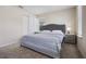 Bedroom with a grey headboard bed frame and a large window with blinds at 4353 Lana Ave, Davenport, FL 33897