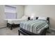 Bedroom with two twin beds, a large window with blinds, and neutral colored carpet at 4353 Lana Ave, Davenport, FL 33897