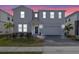 Charming two-story home featuring a well-manicured lawn, stone-paved driveway, and an attached two-car garage at 4353 Lana Ave, Davenport, FL 33897