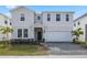 Charming two-story home featuring a paved driveway and an attached two-car garage at 4353 Lana Ave, Davenport, FL 33897