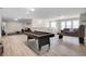 Spacious game room featuring a pool table, cozy seating area, and lots of natural light at 4353 Lana Ave, Davenport, FL 33897