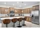 Stylish kitchen with modern lighting, island seating, stainless steel appliances, and ample cabinetry at 4353 Lana Ave, Davenport, FL 33897