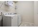 Laundry room features modern appliances, tile flooring, and overhead storage at 4353 Lana Ave, Davenport, FL 33897