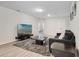Modern living room with a large TV, comfortable seating, and neutral decor at 4353 Lana Ave, Davenport, FL 33897